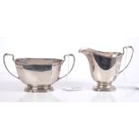 1930s silver cream jug of octagonal faceted form, in the Art Deco style, with angular loop handle,