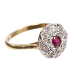 Early 20th century ruby and diamond cluster ring with an oval mixed cut ruby surrounded by old cut