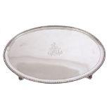 George III silver tray of oval form, with engraved armorial crest and monogram and beaded border,