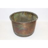 Large antique riveted copper vessel of hemispherical form with everted rim,