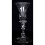 Georgian wine glass with waisted bell-shaped bowl and clear base on annulated knopped stem with