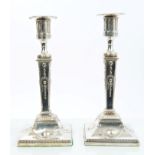 Pair George III silver candlesticks with tapering columns and stamped classical decoration,