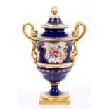 Victorian Royal Worcester urn and cover with floral reserves on blue and gilt ground,
