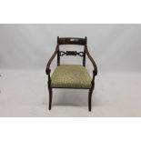 Regency mahogany and brass inlaid elbow chair with tablet back and stuffover seat on sabre legs
