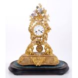 Ornate mid-19th century French gilt metal and porcelain mounted mantel clock with white enamel dial