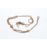 Edwardian rose coloured metal Albertina with fancy links tassel drop,