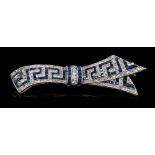 Art Deco sapphire and diamond bow brooch, the stylised ribbon with a Greek key design,