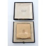 1930s yellow metal matchbook case with engine-turned decoration, stamped - 9ct, in fitted case,