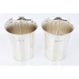 Matched pair of early 20th century silver beakers of cylindrical form, with flared rims,