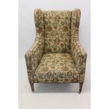 Formerly the property of Sir Alfred Munnings: An Edwardian wing armchair on square taper legs.