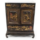 Late 19th century Japanese black and gilt lacquered table cabinet with painted chinoiserie