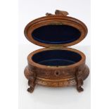 Late 19th century Black Forest carved lindenwood jewellery box of oval form,