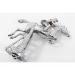 Vintage chromium plated car mascot - a figure on a horse jumping a fence,
