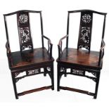 Pair of Chinese pierced and carved elm elbow chairs,