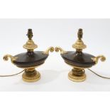 Pair of bronzed and gilded table lamps in the form of squat Grecian urns with twin scroll handles