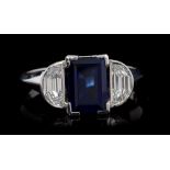 Sapphire and diamond ring, the rectangular step cut blue sapphire weighing 2.