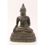 Chinese Qing period bronze figure of Buddha in seated pose, with green / brown patination, 16.