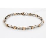 White and yellow gold (9ct) diamond line bracelet with fourteen articulated white gold links,