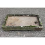 Antique Cotswold stone sink of typical rounded rectangular form,