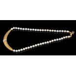 Cultured pearl necklace with a yellow metal and pavé set diamond section to the centre,