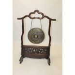 Chinese brass gong on ornate carved and pierced hardwood stand,