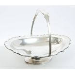 1920s silver swing-handled cake basket of oval form, with shaped border,