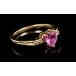 Pink sapphire and diamond ring, the heart-shaped pink sapphire flanked by diamonds to the shoulders,