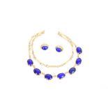 Yellow metal and lapis lazuli necklace with seven oval cabochons in rub-over setting,
