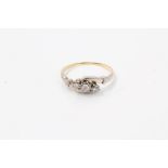 Diamond three stone ring with three brilliant cut diamonds in platinum crossover setting,