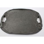 Art Nouveau beaten pewter twin handled tray, sinuous oval form with stylised floral motifs,