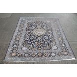Kashan rug with meander floral ornament against a navy blue ground in multiple meander borders,