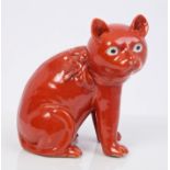 Rare 19th century Chinese export red glazed porcelain cat with bow on collar, in inquisitive pose,