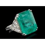 Large emerald and diamond cocktail ring, the rectangular step cut emerald weighing approximately 29.
