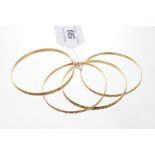 Four Italian yellow metal bangles,