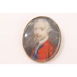 Antique portrait miniature on ivory depicting a gentleman wearing a red coat,