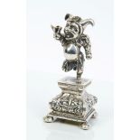 Continental white metal model of a jester with opening belly compartment enclosing a child,