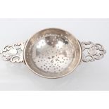 George I Britannia Standard silver lemon strainer with pierced bowl and twin cast scrolling handles,
