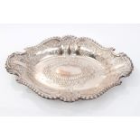 Victorian silver dish of shaped oval form, with embossed scroll and floral decoration,