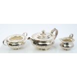 Edwardian silver three piece tea set - comprising teapot of half-fluted form,
