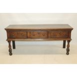 Mid-18th century oak dresser base with three frieze drawers raised on turned and block legs,