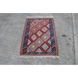 Kelim rug with allover lozenge motifs in geometric borders,