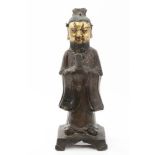 Chinese Qing period bronze and parcel gilt figure of a bearded man in robes, holding a tablet, 23.