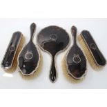 George V silver and tortoiseshell mounted five piece dressing table set - comprising pair