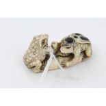 Good quality late 19th century Japanese carved ivory figure of two toads on a lily pad with stalk