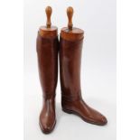Pair of brown leather hunting boots with wooden trees