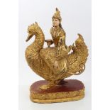 Burmese carved gilt and polychrome painted figure of a goddess on goose's back,