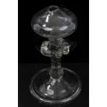 18th century glass lacemakers' oil lamp with swollen knopped stem on splayed folded foot,