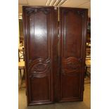 19th century French oak armoire with concave cornice and enclosed by a pair of carved panel doors