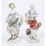 Pair of 18th century Derby figures of young couple with baskets, lamb and flowers on rococo bases,