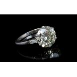 A fine diamond single stone ring, the transitional round brilliant cut diamond weighing 4.